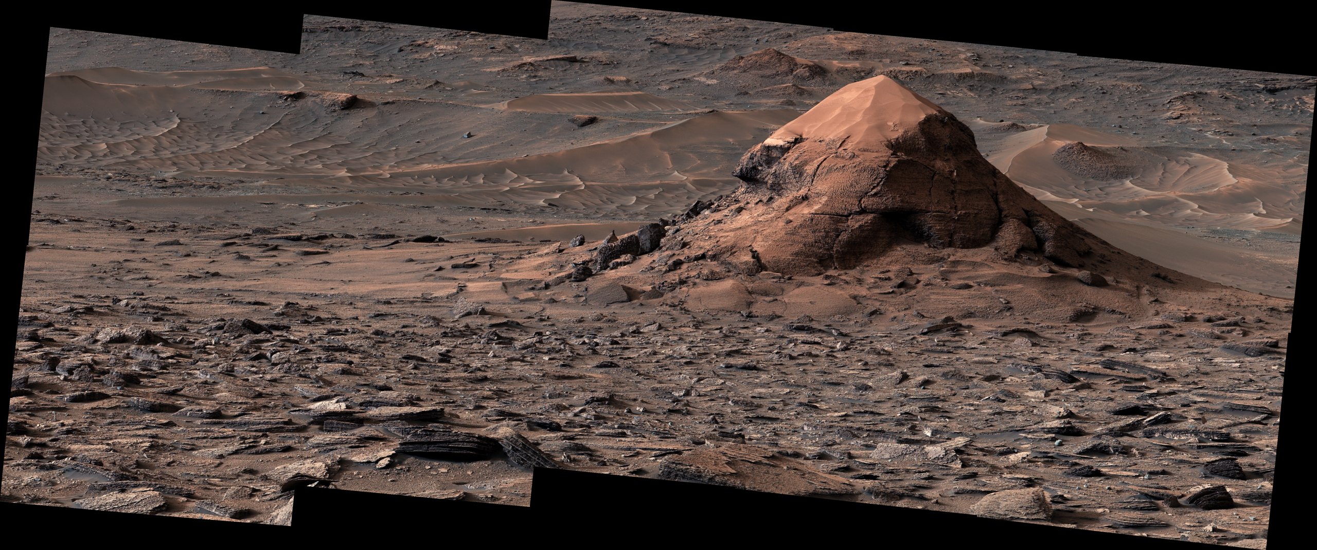 A sand-capped rock butte nicknamed Miraflores surrounded by polygon-covered terrain on Mars